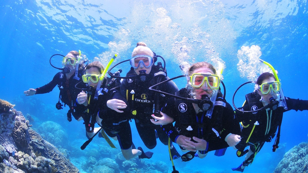 Scuba diving group over the coral reef in Cairns