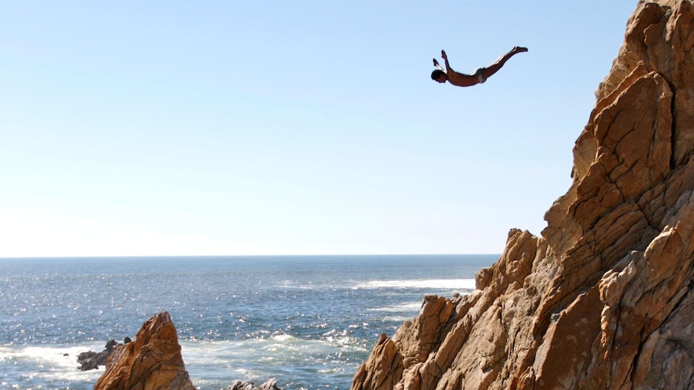 Cliff diver midair in Acapulco
