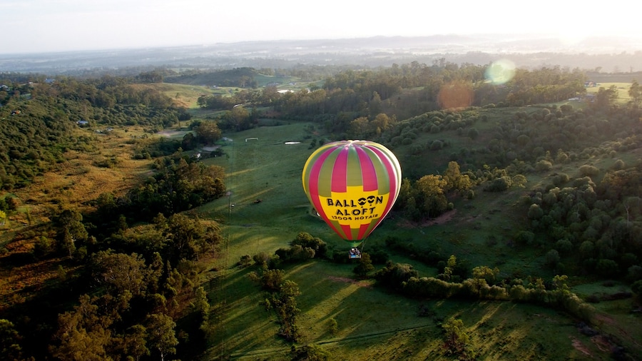 hot air ballon floats above landscape in Sydney