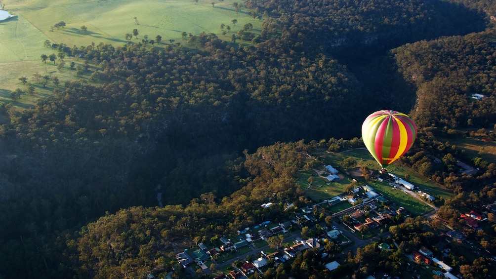 Show item 2 of 4. hot air ballon floats high above landscape in Sydney