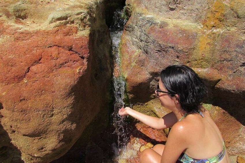 Multi-colored cave with an invigorating bath.