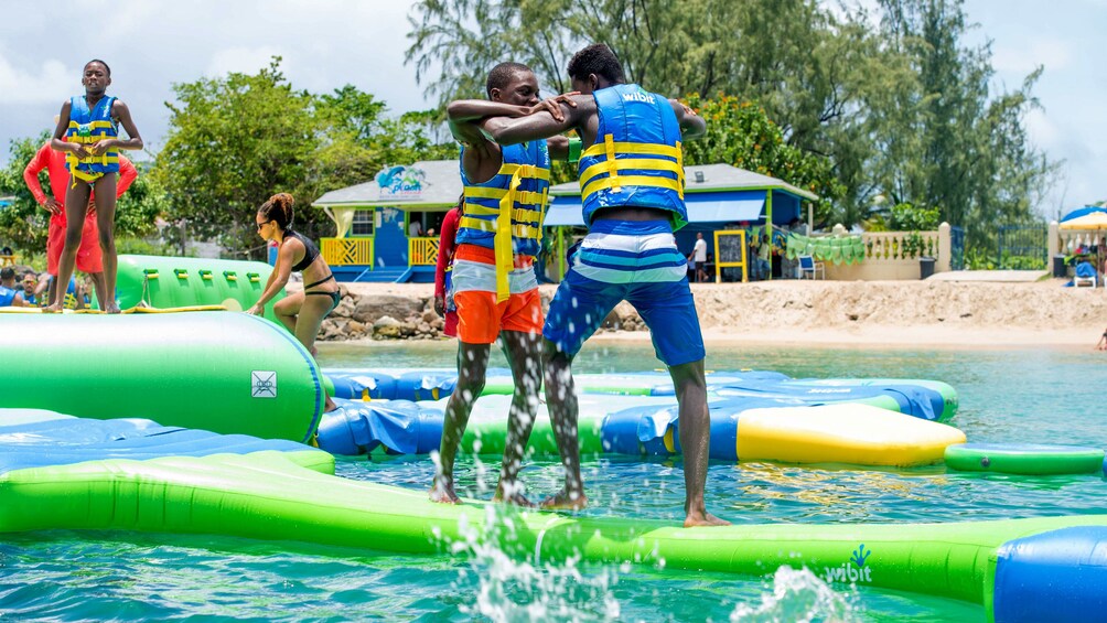 Pair of young men playing at Splash Island Water Park in St Lucia