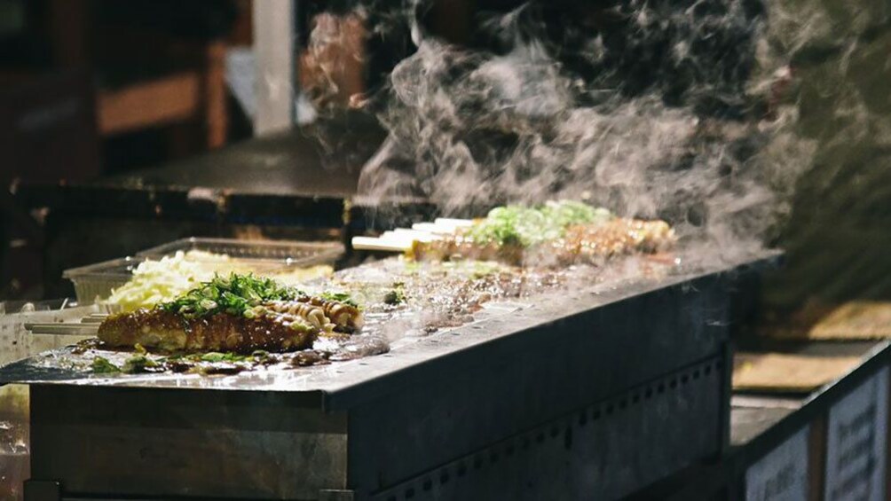 Show item 5 of 5. Grill cooking meat on the street