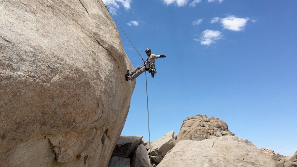 Show item 1 of 4. Man enjoying the scenic views on the Rappelling Adventure at Joshua Tree