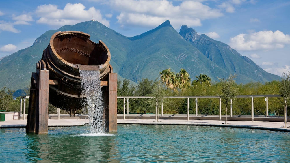 fountain with mountains in the background in Monterrey
