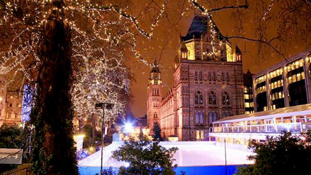 Snow covered London at night with Xmas lights