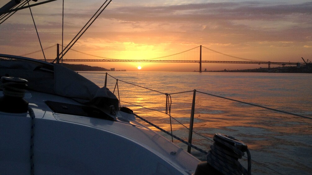 Sunset over bow of boat in Lisbon