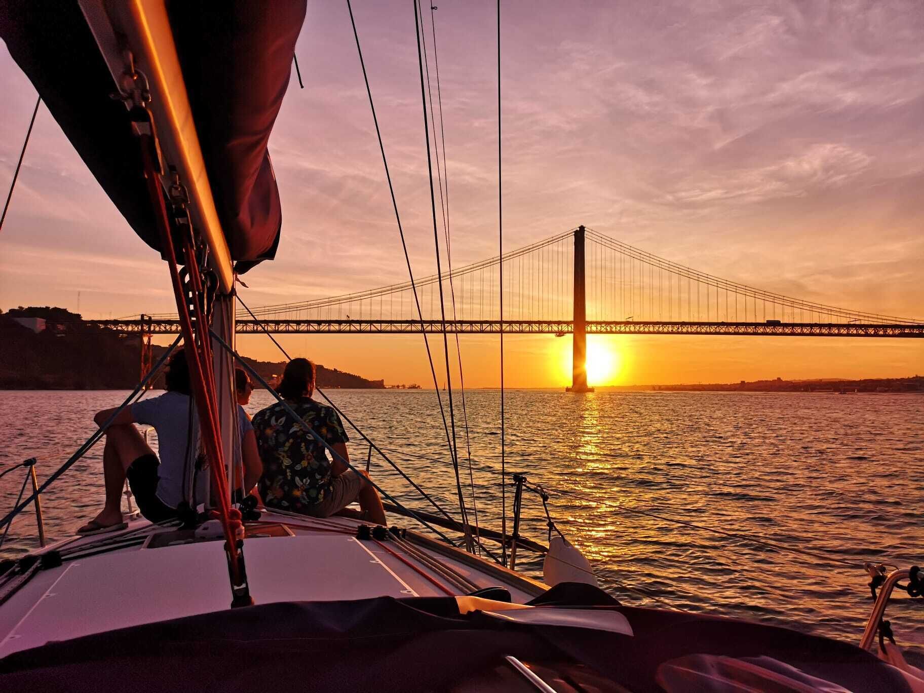 The Lisbon Sunset Sailing Experience with a drink
