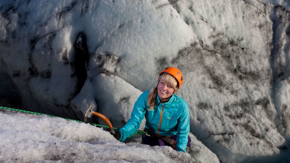 Woman climbing a glacier in iceland