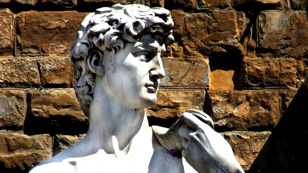 Show item 1 of 5. Outdoor sculpture of David next to brick wall