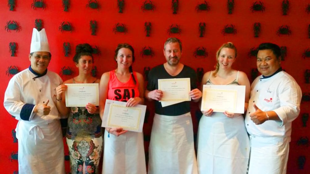 Cooking class in Thailand holding certificates