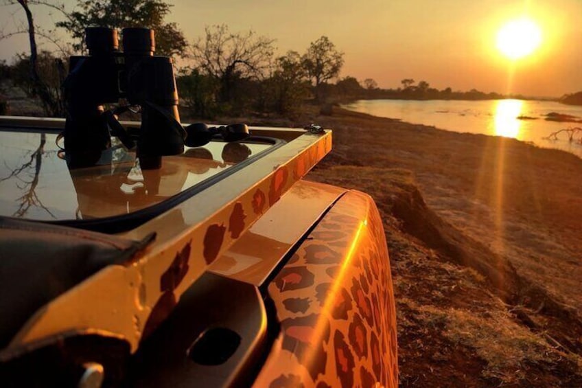 Camera, binoculars , zambezi during the sunset