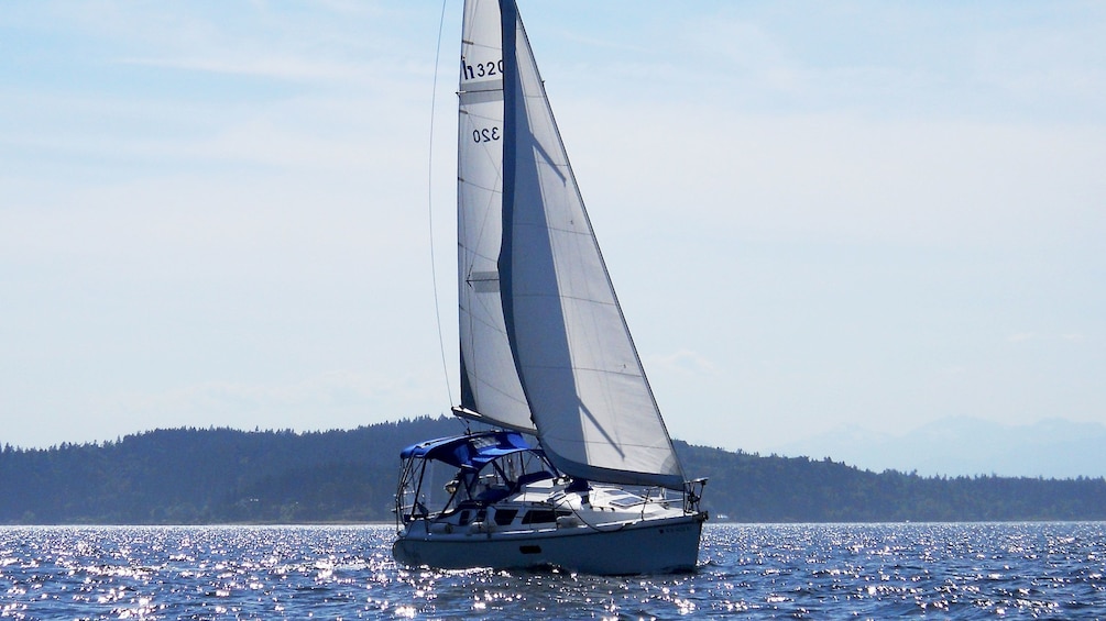 Sailboat making turn in waters of Puget Sound.