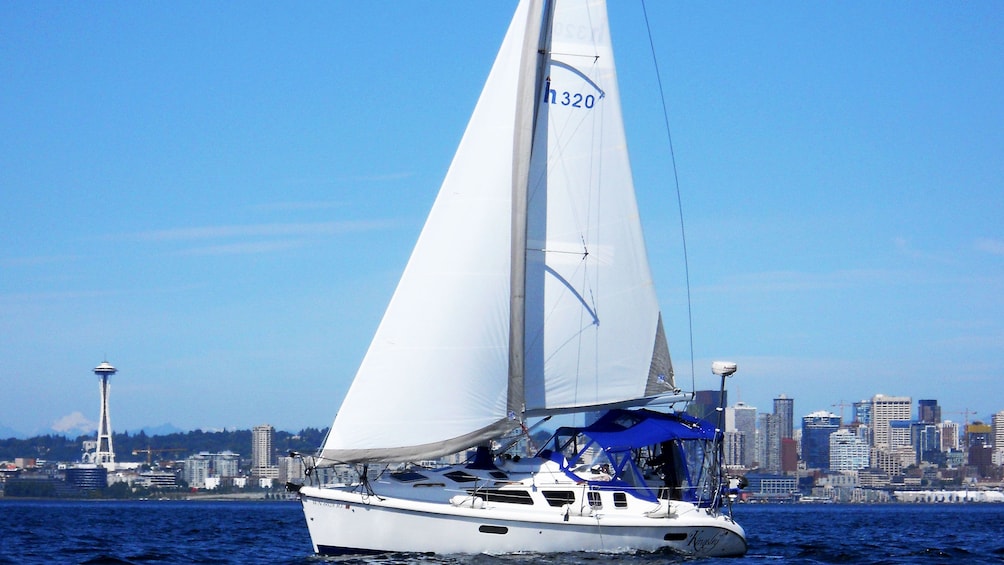 Boat sailing with Space Needle and Seattle in the background in Puget Sound