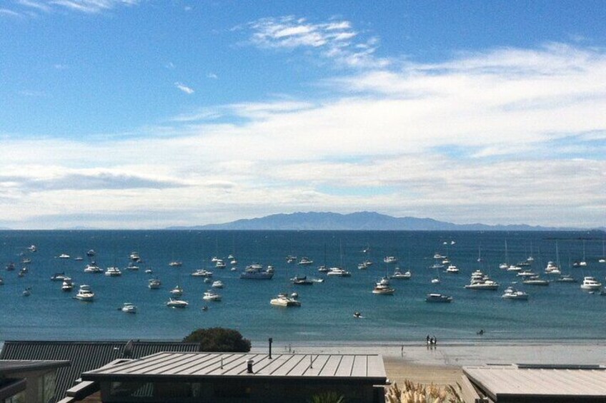 View driving through Oneroa Village overlooking Oneroa bay