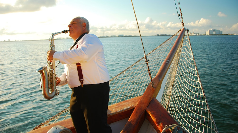 Old Man playing a saxophone on a boat in Mexico