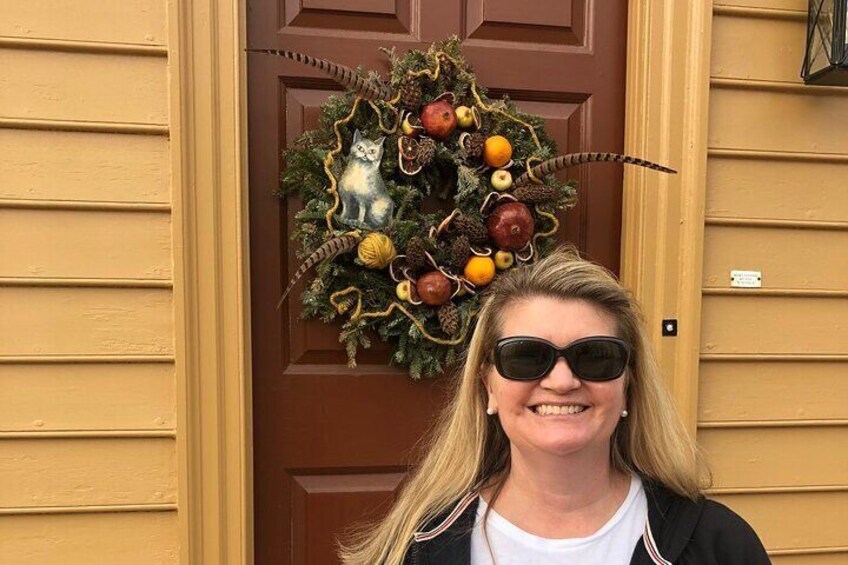 Colonial Williamsburg wreath with feathers, traditional fruit, cat and feathers