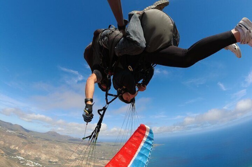 Tandem paraglider head upside down