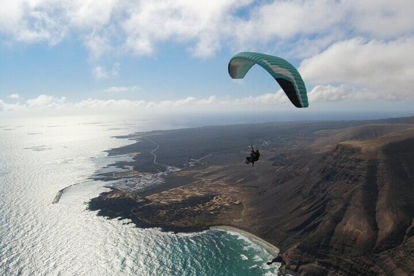 Two-seater paraglider over Orzola beach