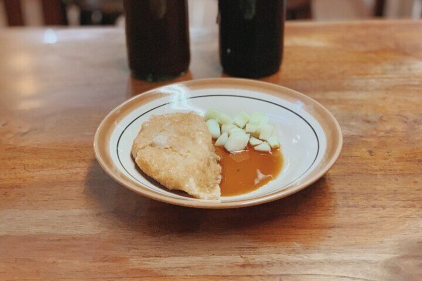 Indonesia's traditional fish cake with egg indside it and sweet-sour sauce.