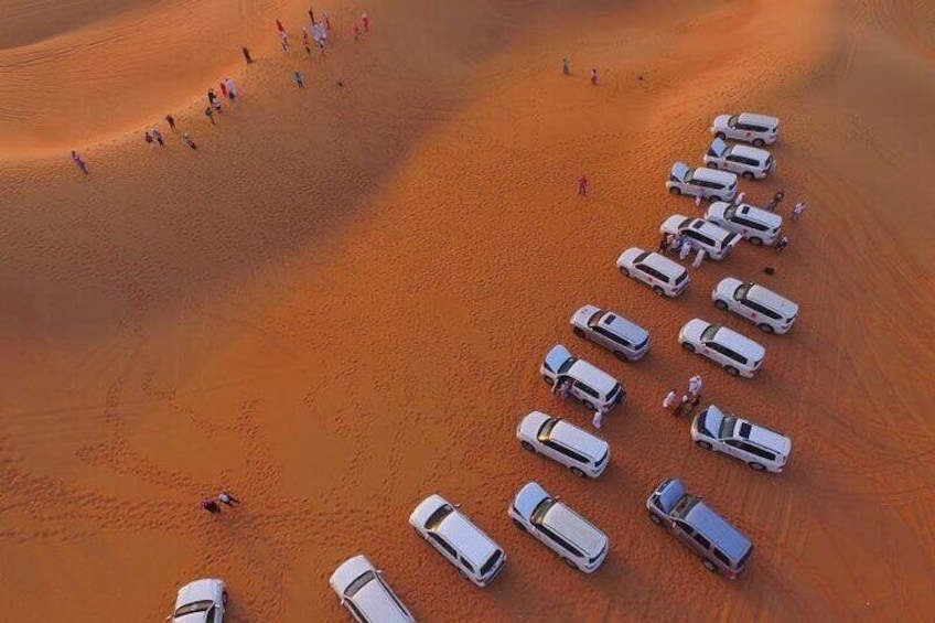 Arial view group of cars at picture stop in the desert