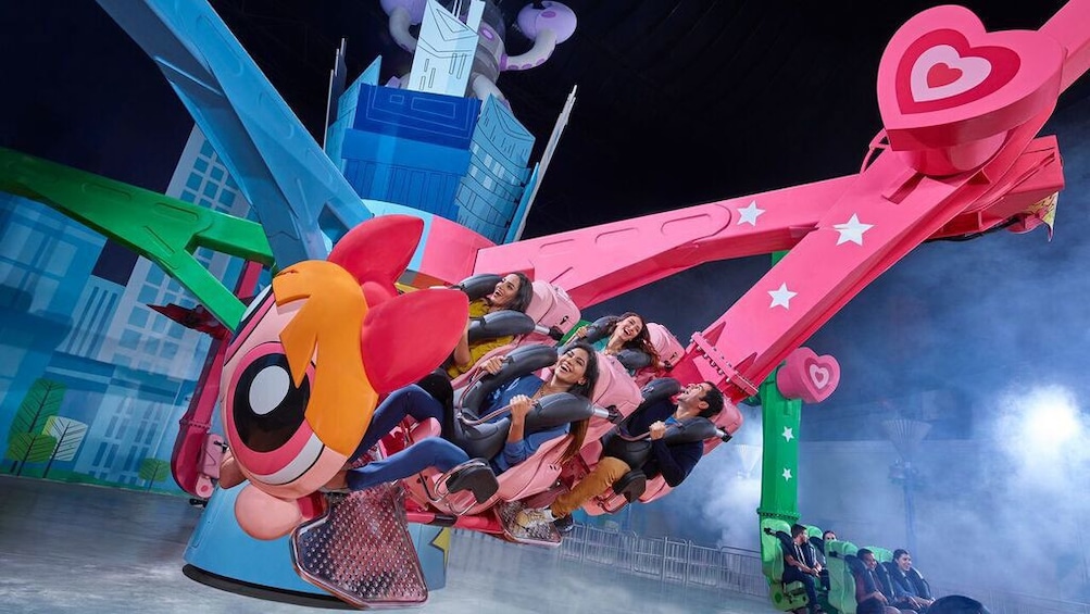 People in spinning amusement park ride in IMG Worlds of Adventure