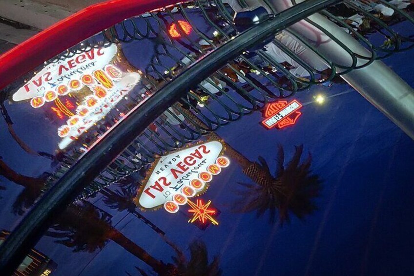 The limo reflecting the classic Las Vegas Sign