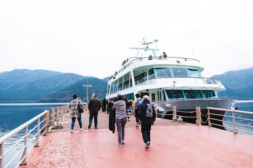 Travelers board the ferry on a postcard-perfect Lake Ashi.