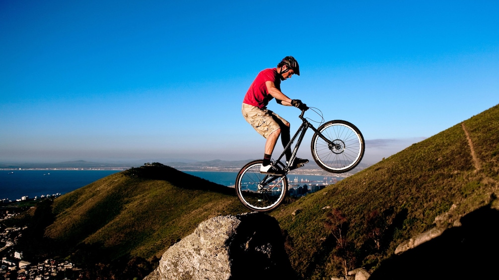 Mountain Biker balance bike on rock on Table Mountain