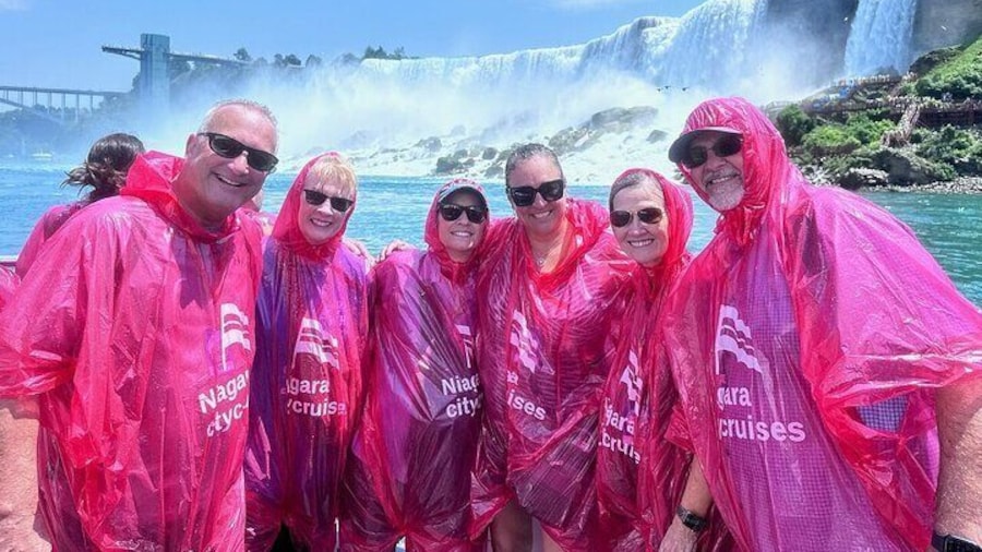 A group of happy adults enjoying the experience from the deck of the Hornblower boat cruise