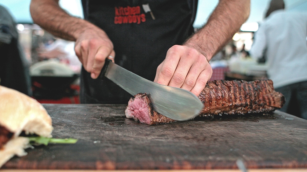 Vendor slicing meat at a market in Cape Town