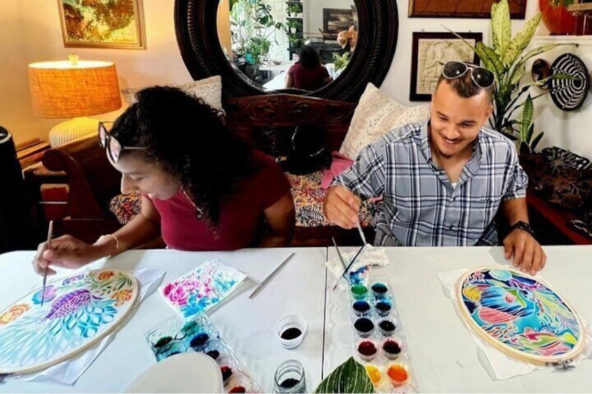 Couple enjoys painting their pre-waxed batik hoops in my home studio in Aventura, Florida.