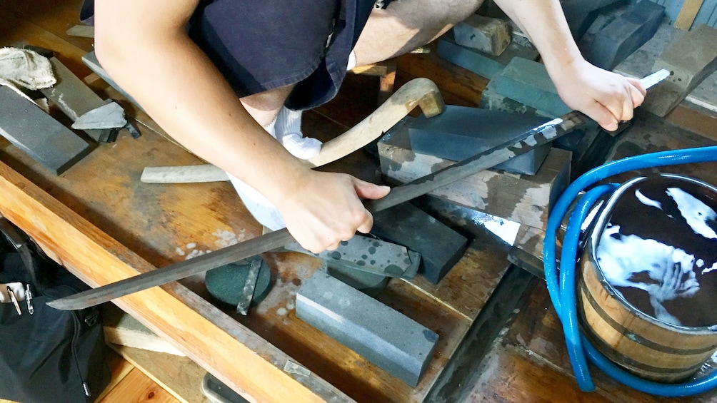 Show item 3 of 5. Blade of sword being made by sword maker in Kyoto