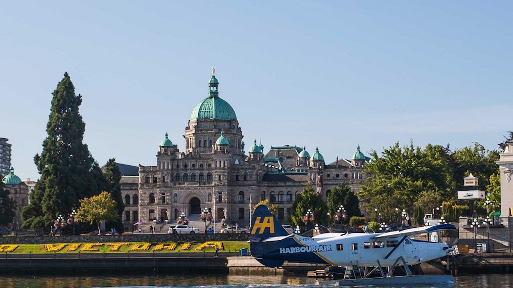 Seaplane sitting at dock near the British Columbia Parliament building in Victoria