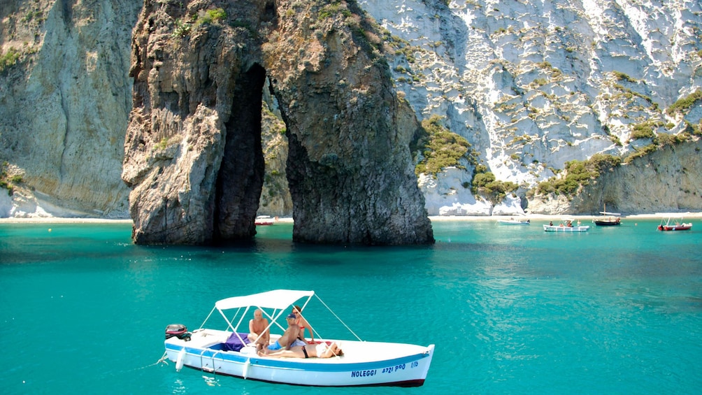 People on small boat moored in bay of Ponza Island
