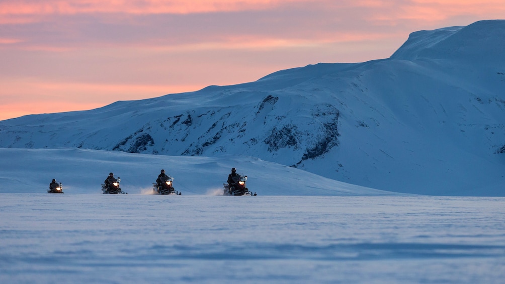 Snowmobilers in the mountains