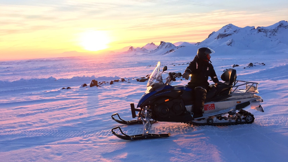 Snowmobiler in the mountains