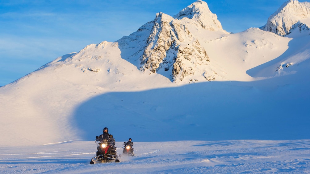 Snowmobilers in the mountains