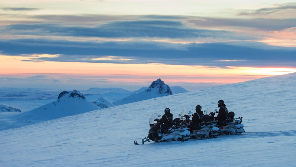 Snowmobilers in the mountains