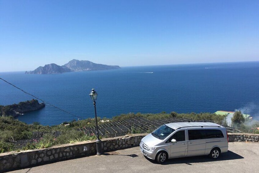AequaLimo's mercedes-benz vehicle, with Capri in the background, ready to start our Amalfi Coast Tour