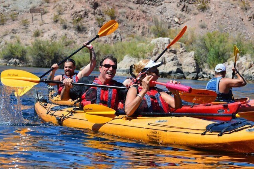 Some guests splashing around with their paddles and water guns