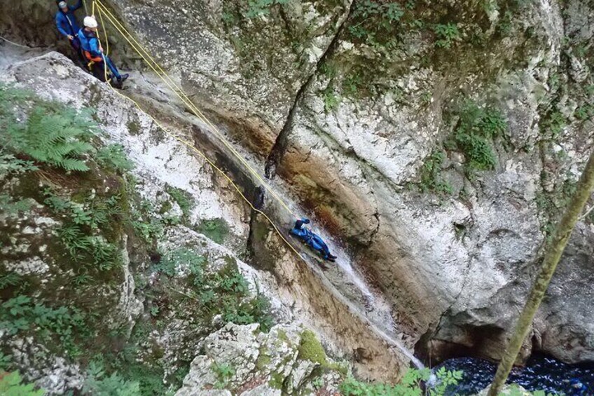 Repelling in 12m deep waterfall