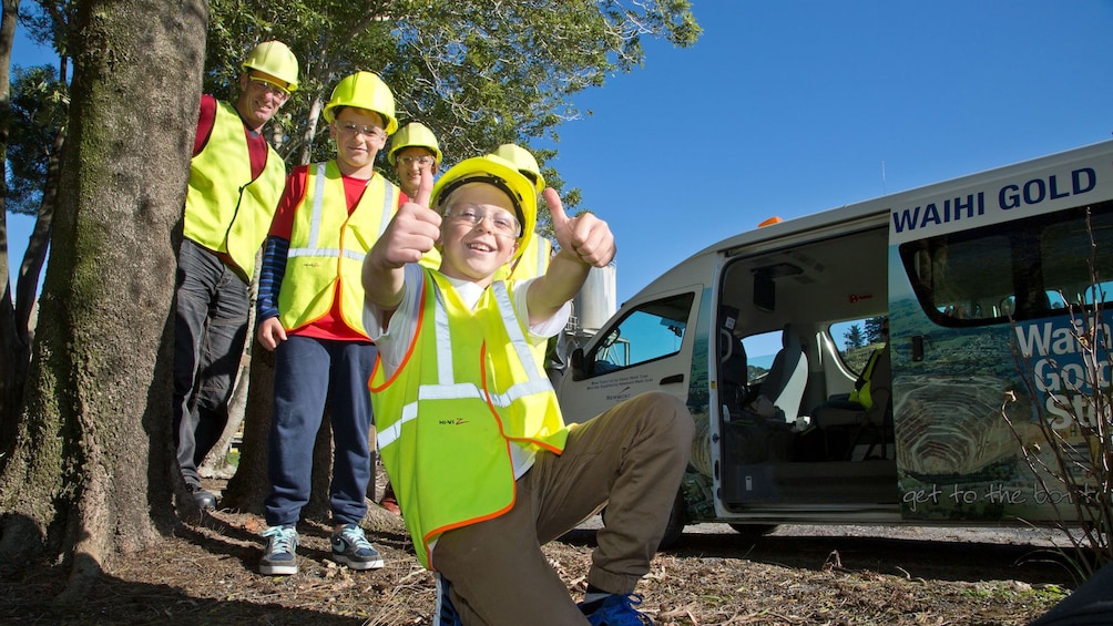 little kid giving a thumbs up with family behind him on Waihi Gold Rush Encounter