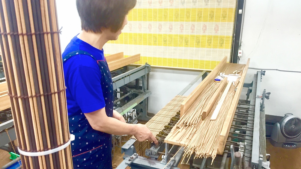 Woman preparing to make Kyoto style Kasumi Bamboo Mats