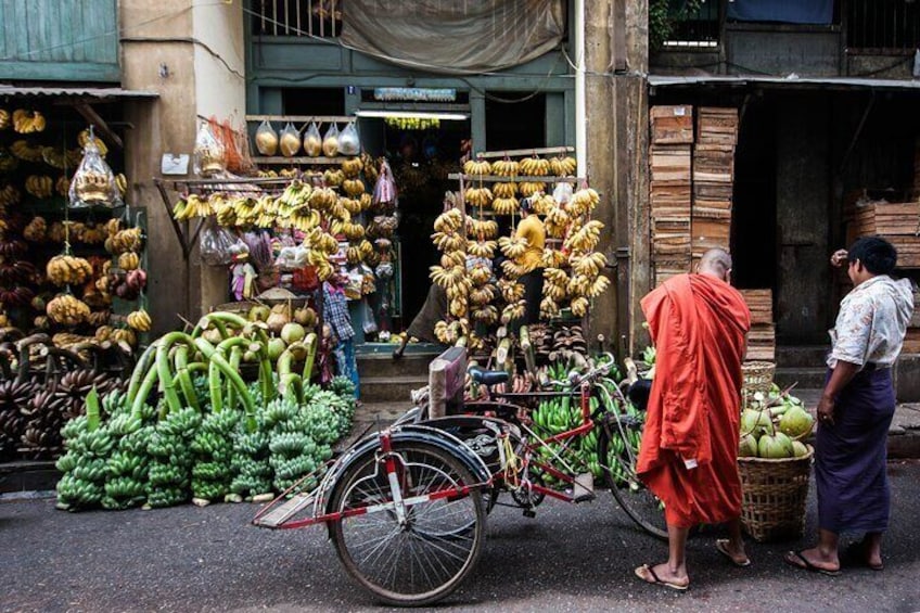 A monk and banana stall in downtown Yangon. 
