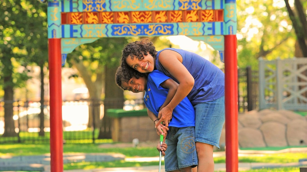 Mother and son putt putt golfing