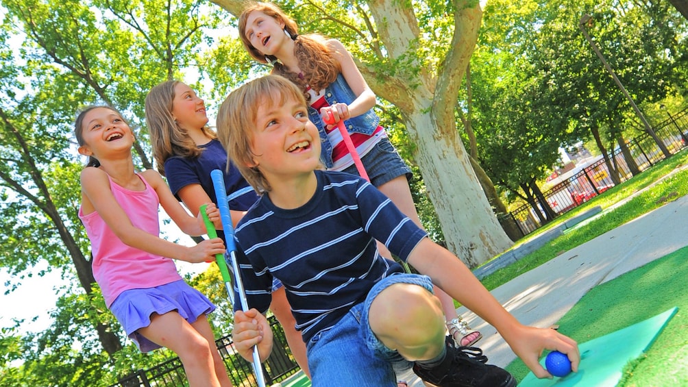 Group of Children Putt Putt golfing