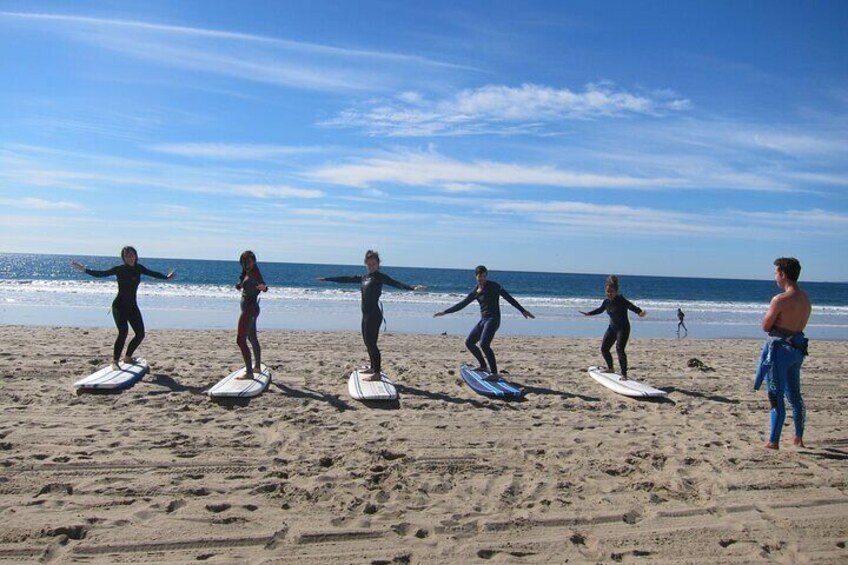 Group practices their pop-up technique on the beach.