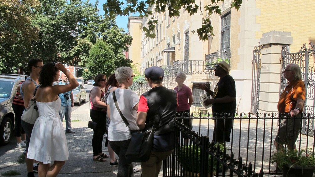 Tour guide and group in Harlem