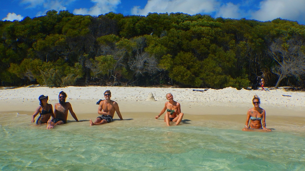 Show item 2 of 5. Four people on a beach in Queensland
